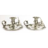 A near pair of silver plated chambersticks,