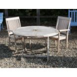 A circular slatted teak garden table,