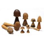 A collection of eight carved wooden mushrooms,