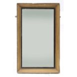 A rectangular gilt and ebonised mirror,