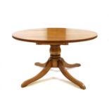 A modern solid oak extending pedestal dining table,