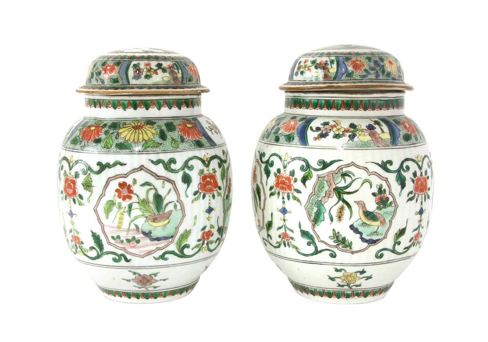 A pair of famille verte jars and covers,