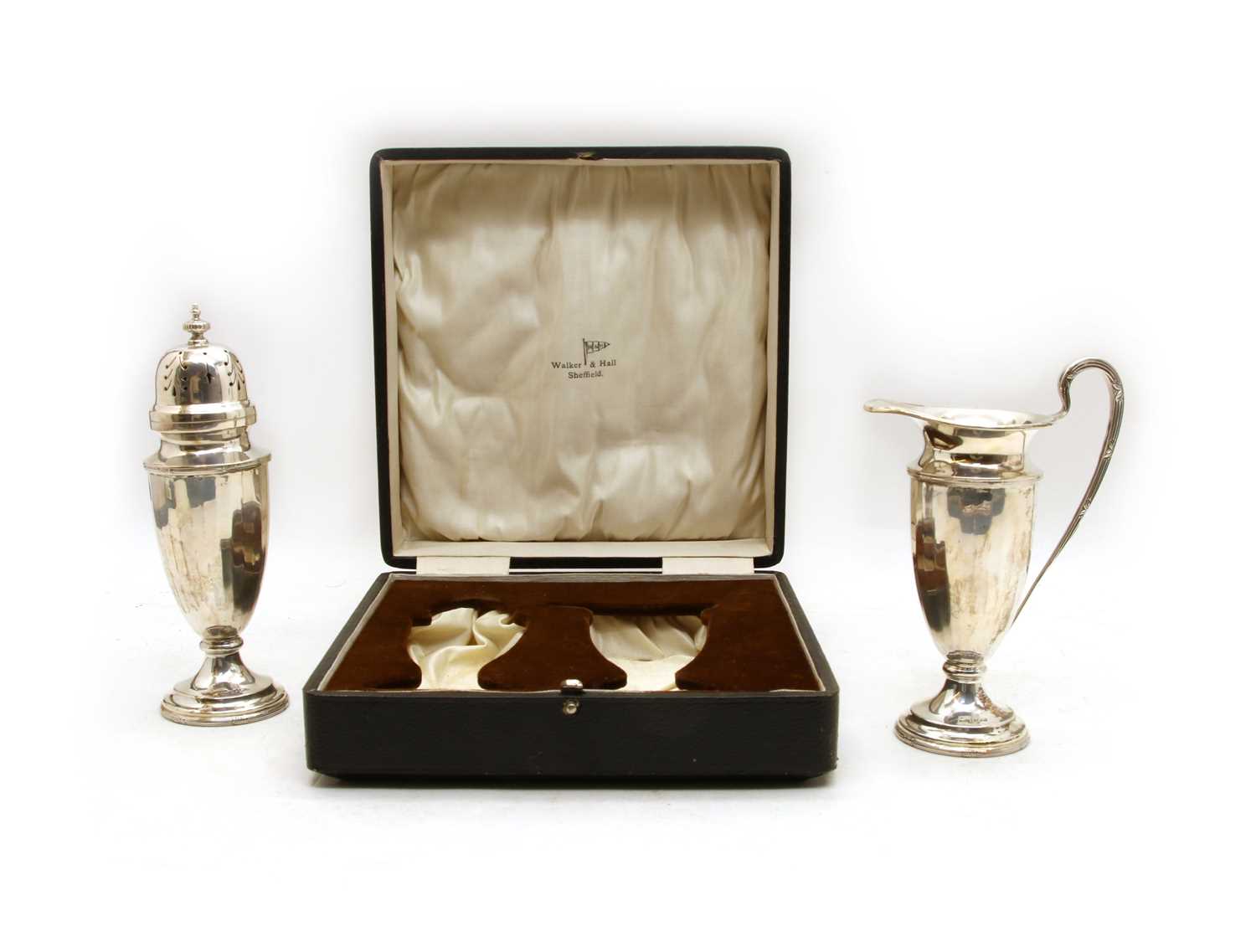 A cased silver sugar caster and cream jug set,