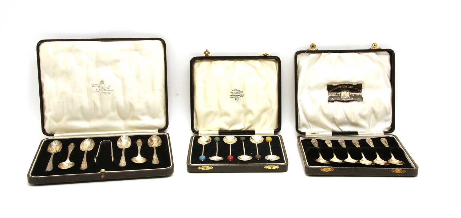 Three silver cased six pieced coffee spoon sets,