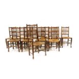 Eleven rush seated oak dining chairs,