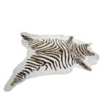 A Zebra print on cow hide rug,