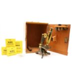 A mahogany cased brass monocular microscope,