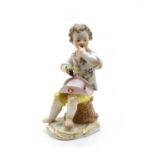A Meissen figure of boy eating grapes,