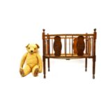 An old teddy bear in a wooden cot