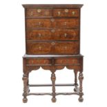 A walnut and amboyna chest on stand,