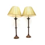 A pair of bronze table table lamps with gilt bands and crenelated drip pans,