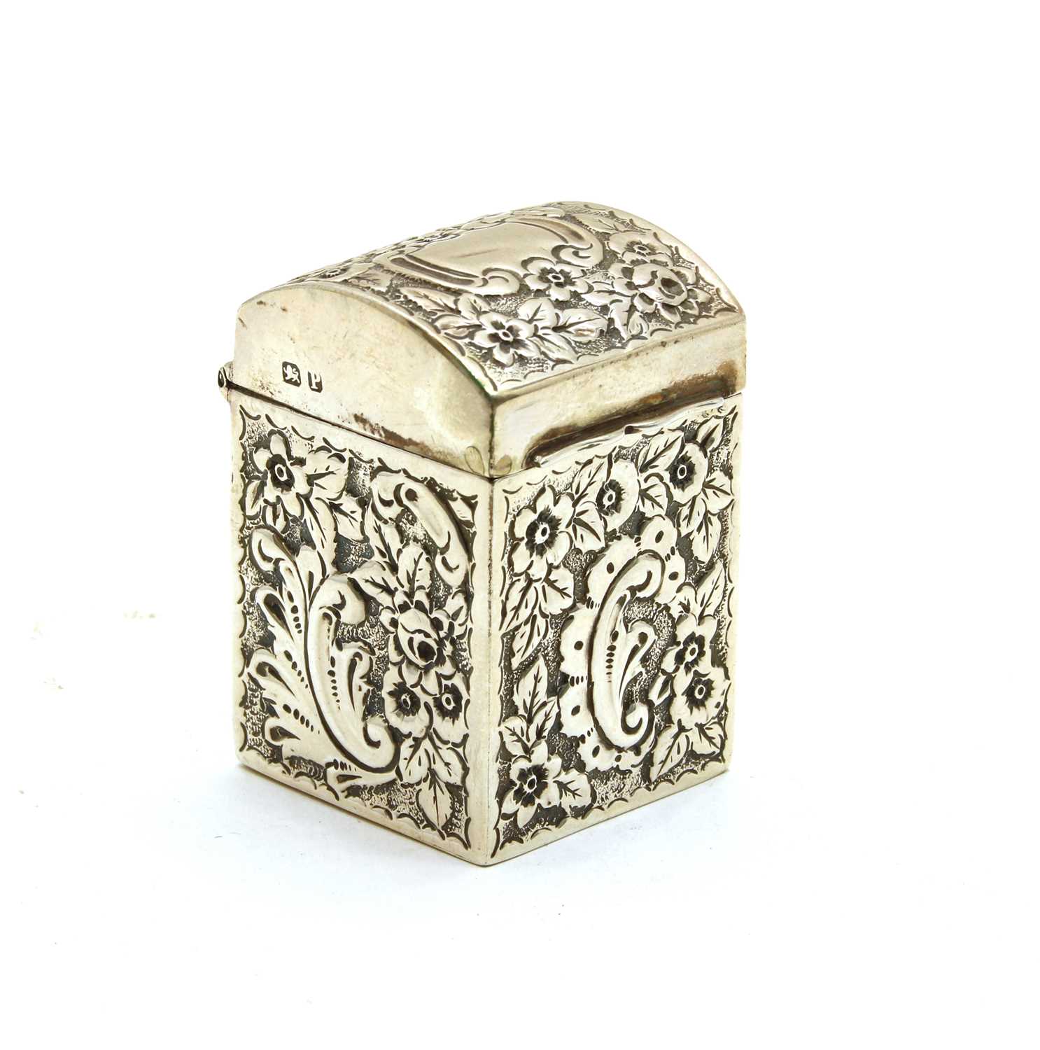 A miniature silver embossed casket with a domed lid,