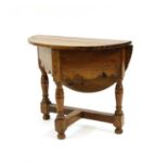 A small 17th century style oak drop leaf table,