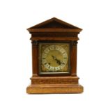 An oak cased mantel clock,