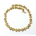 A high carat gold graduated crossover link necklace,