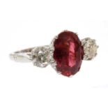 A white gold three stone unheated ruby and diamond ring,