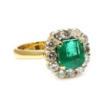 An emerald and diamond cushion-shaped cluster ring,