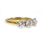 An 18ct yellow and white gold three stone diamond ring,