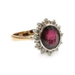 A ruby and diamond oval cluster ring,