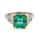 A platinum and gold Colombian emerald and diamond three stone ring,