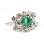 An emerald and diamond three row landscape-shaped cluster ring,