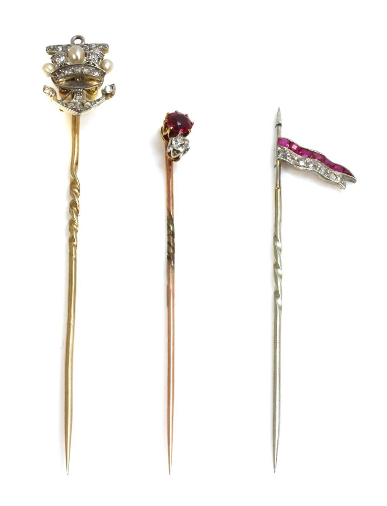 Three diamond set stick pins,