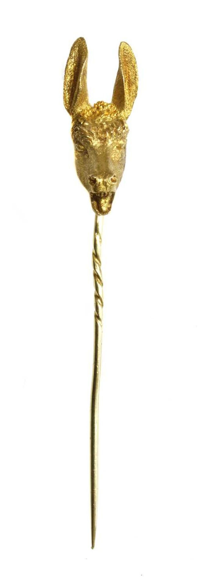 A gold donkey or ass novelty stick pin, late 19th century or early 20th century,