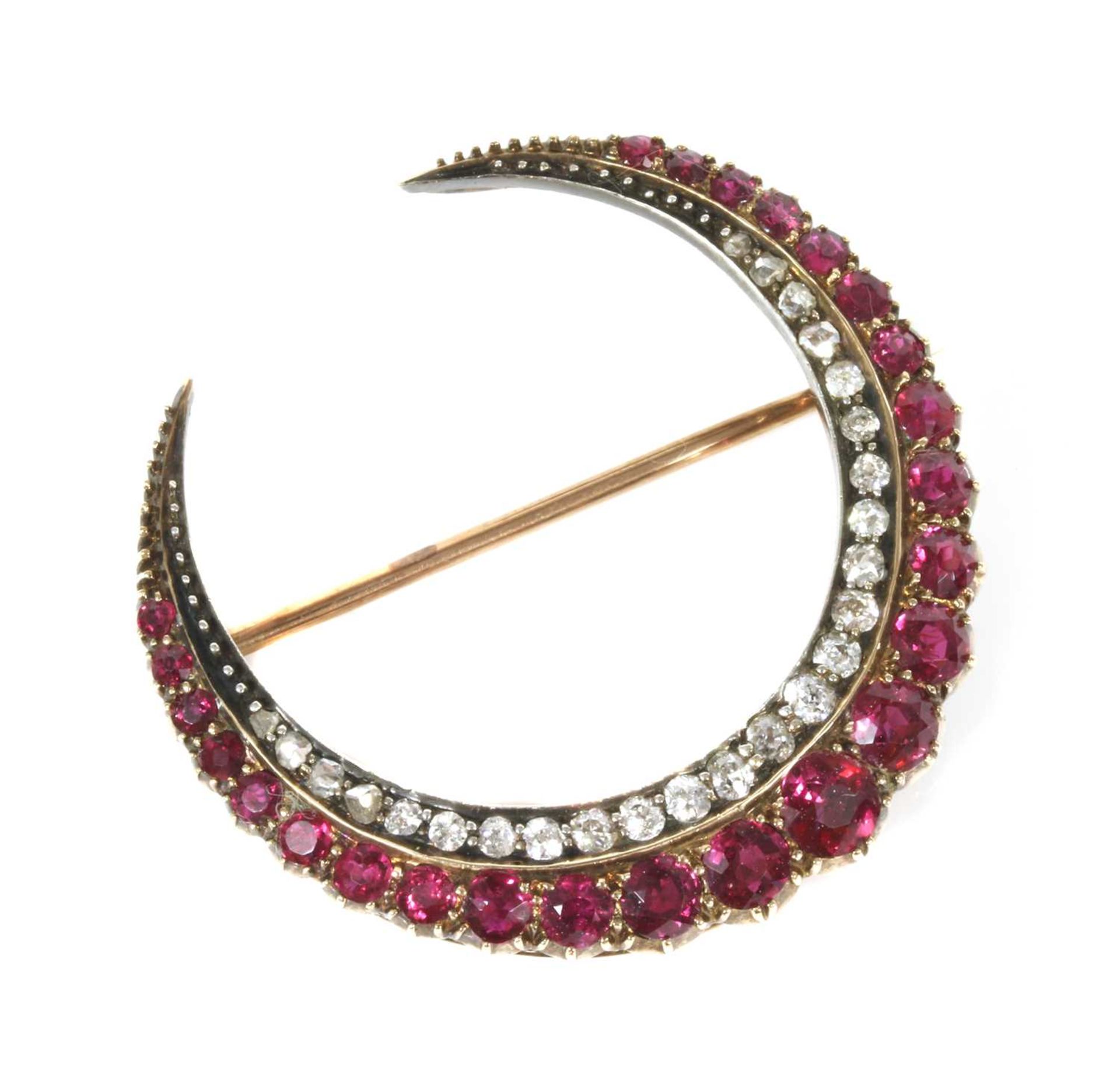 A late Victorian ruby and diamond closed crescent brooch,