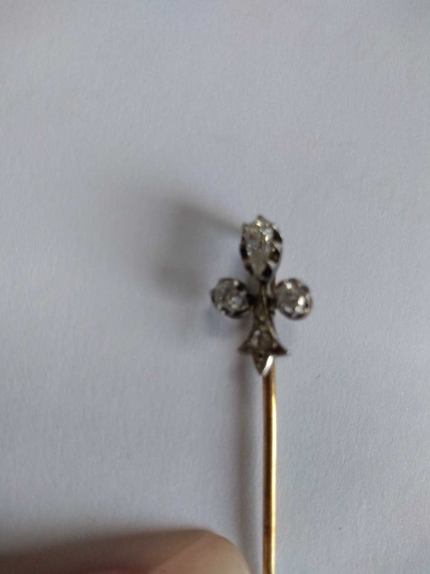 A cased diamond set fleur-de-lys stick pin, early 20th century, - Image 5 of 5