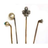 A cased diamond set fleur-de-lys stick pin, early 20th century,