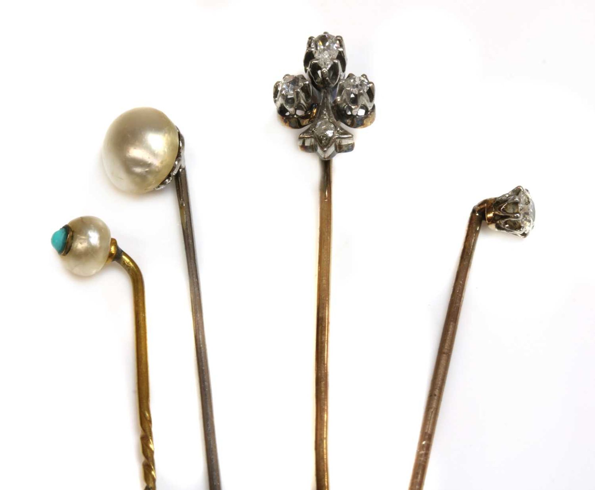 A cased diamond set fleur-de-lys stick pin, early 20th century,