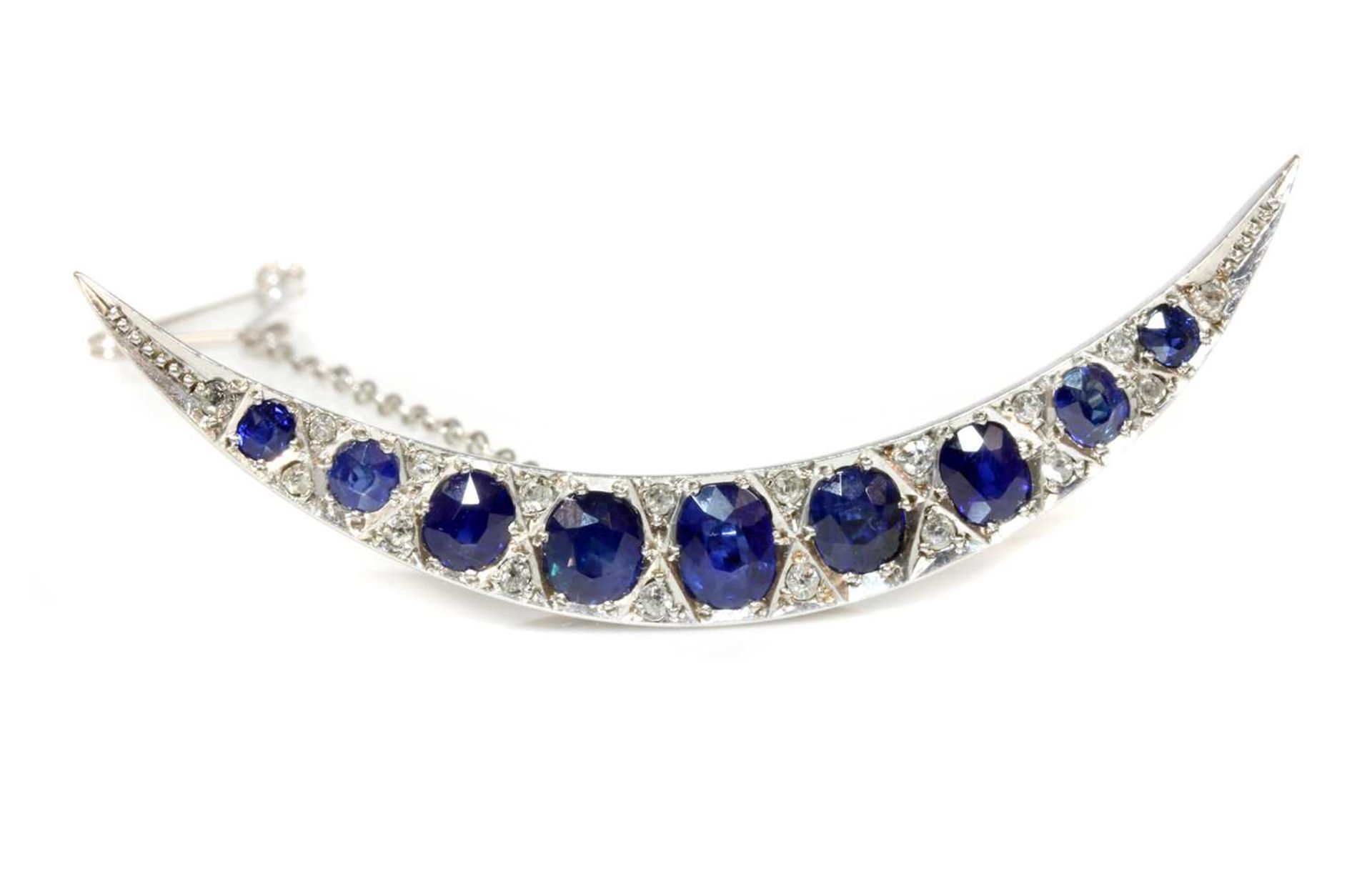 An Edwardian sapphire and diamond crescent brooch, c.1910,