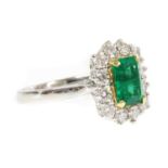 An 18ct white gold emerald and diamond rectangular cluster ring,