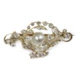 A late Victorian pearl and diamond scrolling brooch,