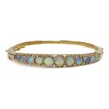 A 9ct gold opal and diamond hinged bangle,