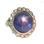 An American star sapphire and diamond oval cluster ring,