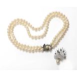 A two row uniform cultured pearl necklace with a sapphire and diamond clasp,