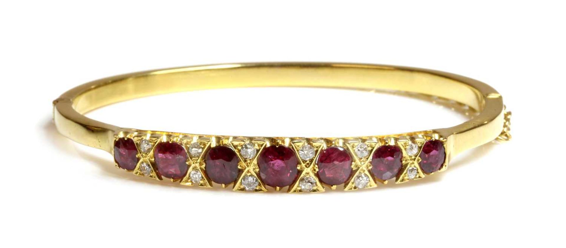 A ruby and diamond hinged bangle,