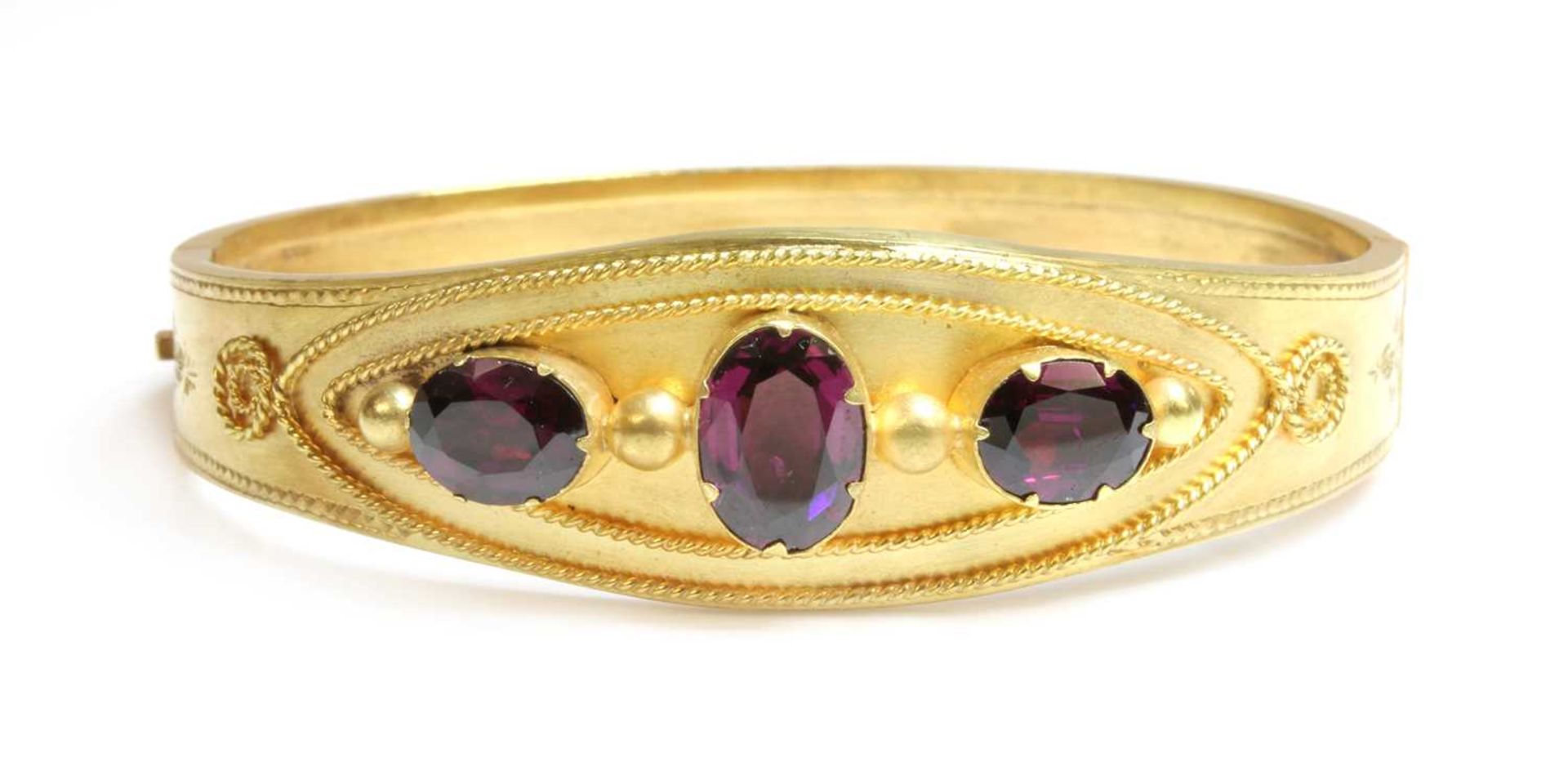 A Victorian garnet set gold bangle, c.1870,