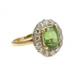 A two colour gold peridot and diamond oval cluster ring,