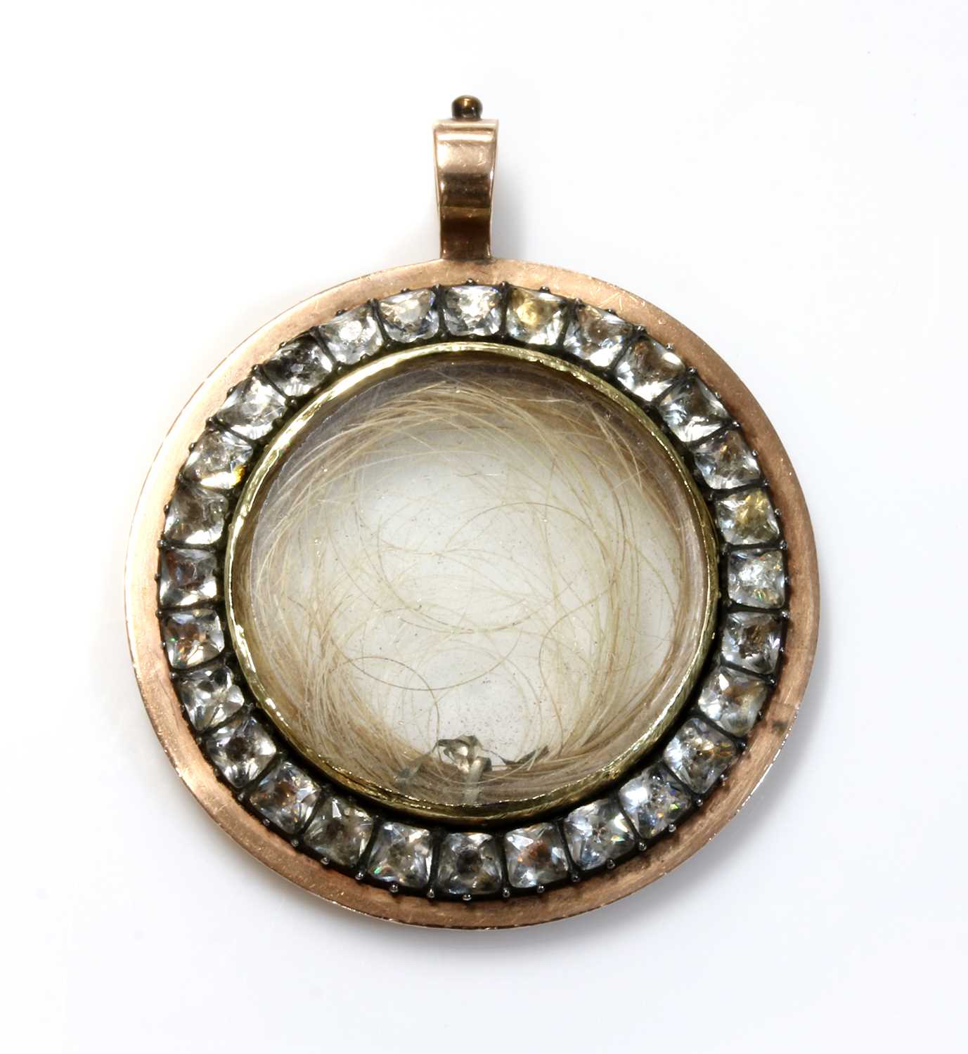 A Georgian gold and paste set circular glazed locket,