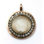 A Georgian gold and paste set circular glazed locket,