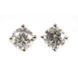 A pair of 18ct white gold single stone diamond stud earrings,