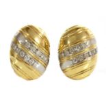 A pair of two colour gold diamond set oval domed earrings,