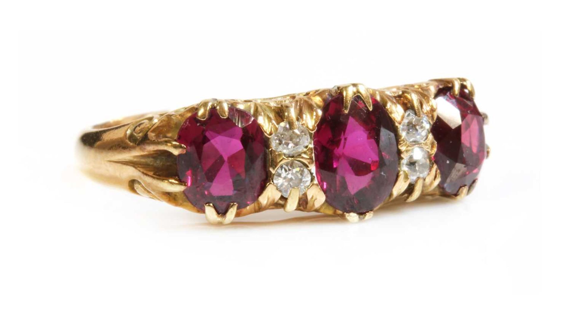 A seven stone ruby and diamond carved head ring,