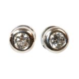 A pair of 18ct white gold single stone diamond earrings by Theo Fennell,