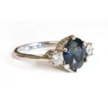 An 18ct white gold sapphire and diamond three stone ring,