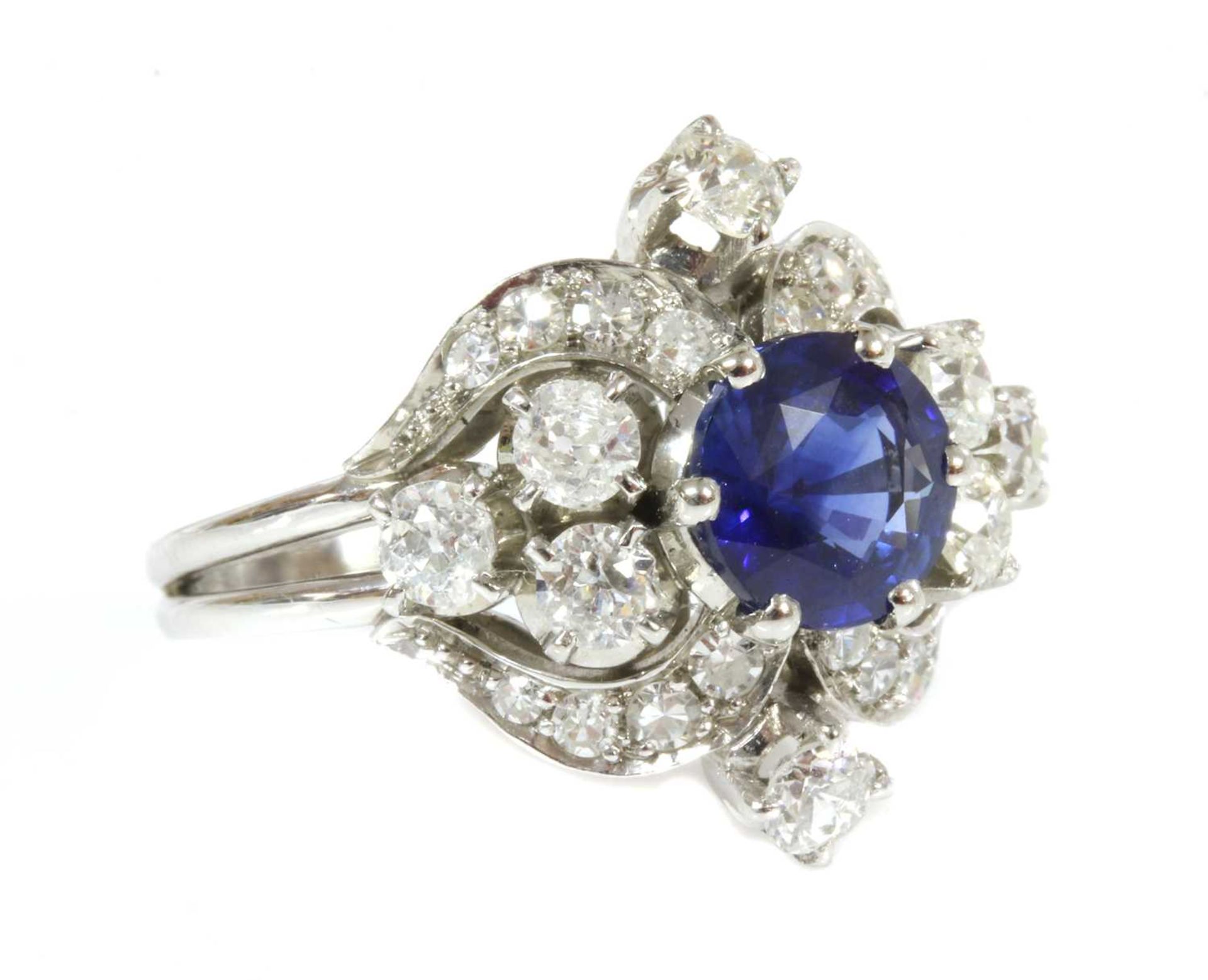 A white gold sapphire and diamond lozenge-shaped cluster ring,