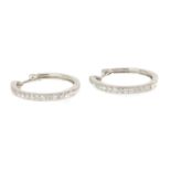 A pair of 18ct white gold diamond set hinged hoop earrings,
