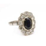 A white gold sapphire and diamond oval cluster ring,